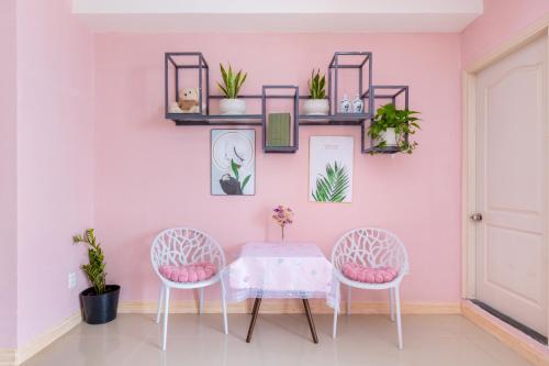 a dining room with a table and two chairs at Căn Hộ "2" OaSky View biển 3 Phòng 5 Giường- Oasky Sea View Apartment in Vung Tau