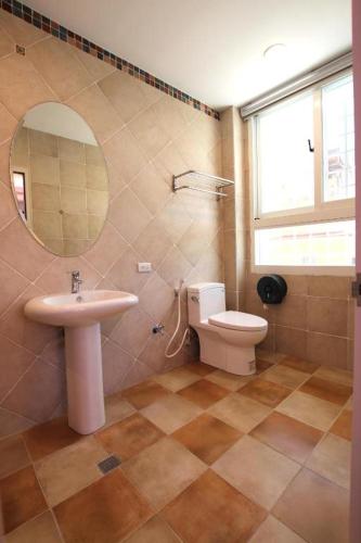 a bathroom with a sink and a toilet and a mirror at Island on the Sea in Kenting