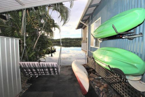 a house with two kayaks on the side of it at Bungalow 32 at Lake Bennett 2 Brm home in Lake Bennett