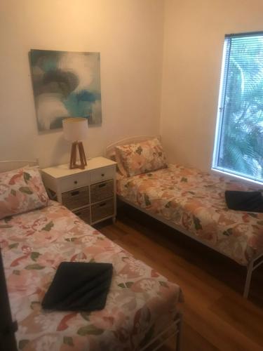 a bedroom with two beds and a window at Bungalow 32 at Lake Bennett 2 Brm home in Lake Bennett