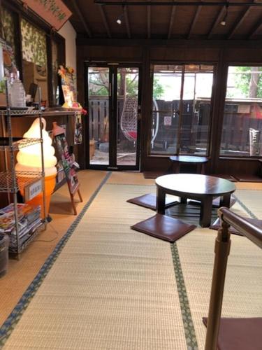 a living room with a table and a room with windows at 2 Double bed and 1 Sofa bed Fullsize bathroom Shinjuku 20 minutes Quiet cozy room Walmart DonDonDonk Station 7 minutes Free parking at Tanashi Station in Nishitokyo