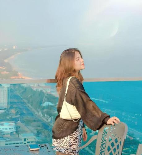 a woman standing at the top of a tower at Căn Hộ "2" OaSky View biển 3 Phòng 5 Giường- Oasky Sea View Apartment in Vung Tau