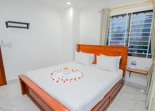 a bedroom with a bed with a bowl on it at Bliss & Beats Hostel in Phnom Penh