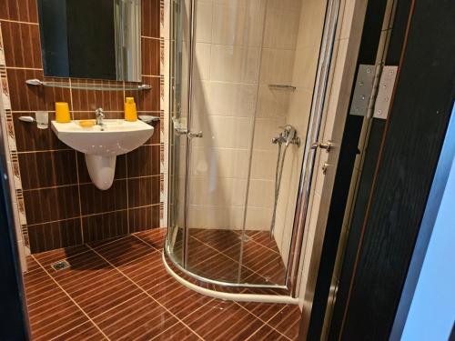 a bathroom with a shower and a sink at Студио за гости на Сарафово in Burgas City