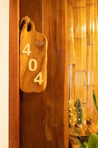 a bag with the number forty four hanging on a wall at Monraumsuk home stay Chiang Mai in Ban Pok Nai