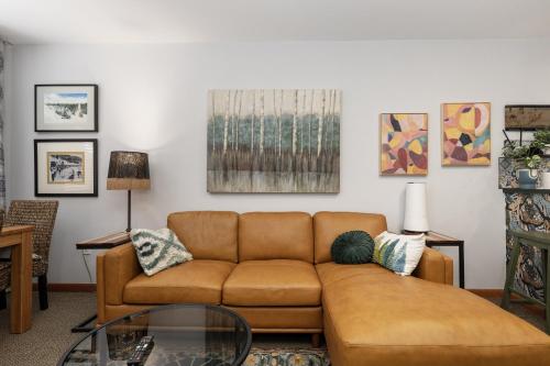 a living room with a couch and a glass table at Premium Unit 1305 - Zephyr Mountain Lodge condo in Winter Park