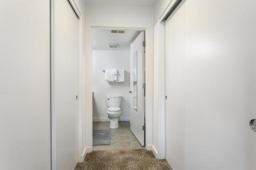 a white bathroom with a toilet in a hallway at River Pines A303 condo in Edwards