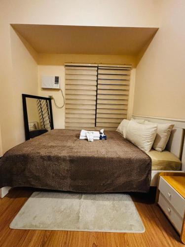 a bed with a stuffed animal on top of it at Relaxation Getaway in Manila