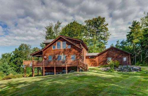 a log home with a large yard at 489OER in Whitefield