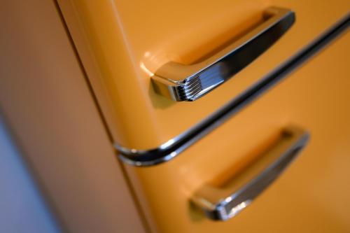 a close up of the handles of a yellow refrigerator at Tweet Apartments with Sauna and optional Breakfast Close To Terme Sveti Martin in Štrigova
