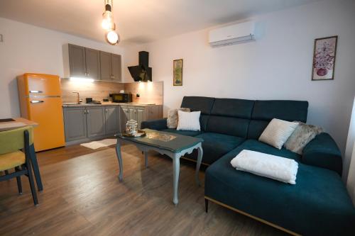 a living room with a couch and a table at Tweet Apartments with Sauna and optional Breakfast Close To Terme Sveti Martin in Štrigova
