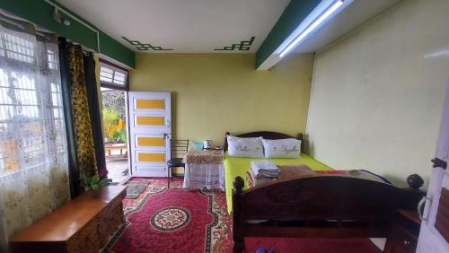 a bedroom with a bed in a room with a window at Viraj Kunj Homestay in Darjeeling