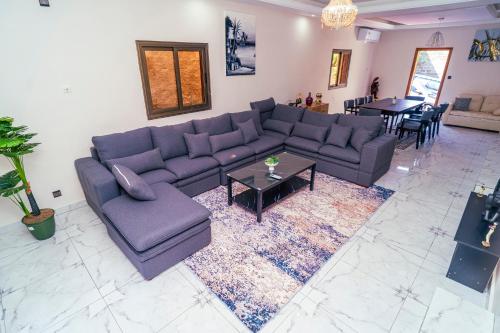a living room with a couch and a table at Baville in Iloneyon-Sekioni