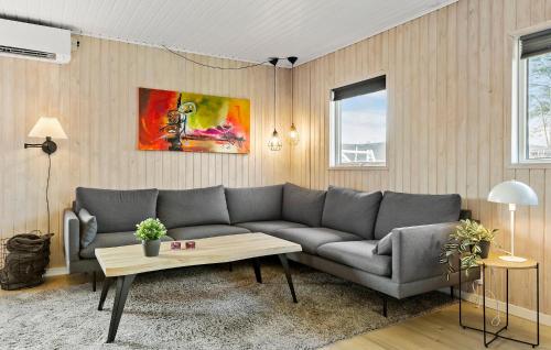 a living room with a couch and a table at 3 Bedroom Lovely Home In Sydals in Neder Lysabild