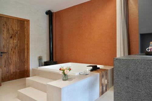 a living room with stairs and a vase of flowers at Anadu Private House in Huzhou