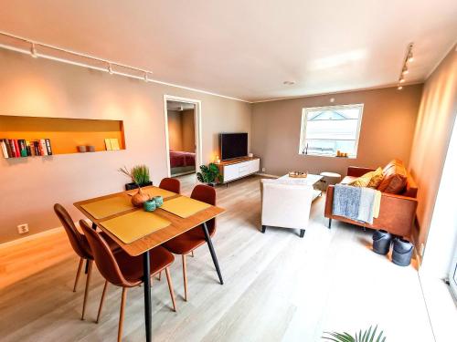 a living room with a table and a couch at Aurora Central Premium Apartment, Bodø in Bodø