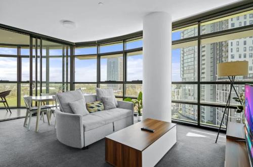 a living room with a couch and a table at 105OP Abnb-Style Spectacular Park View 2BR Apt with Free Parking in Sydney