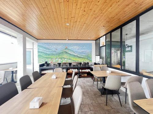 a restaurant with tables and chairs and a painting on the wall at Ghasso Residency in Gangtok