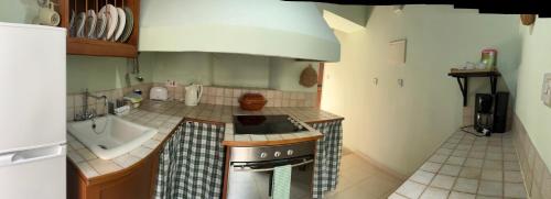 a small kitchen with a stove and a sink at Vasilion Agrotourism in Polis Chrysochous