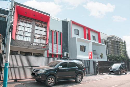 a black suv parked in front of a building at Hotel O Cempaka Place Homestay in Jakarta
