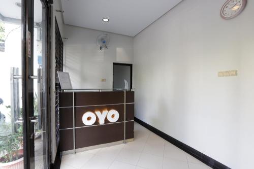 a lobby of an office building with aoops sign on the wall at Hotel O Cempaka Place Homestay in Jakarta