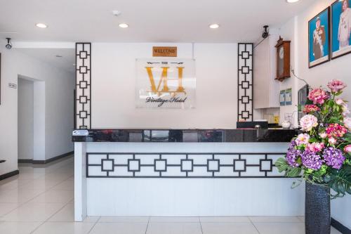 a counter in a store with flowers at Hotel O The Vintage Hotel in Nusajaya