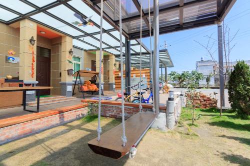 a porch of a house with a swing at Sky Bird Garden B&B in Wujie