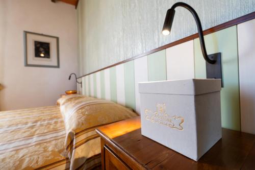 a bedroom with a bed and a lamp on a table at Locanda Poggioleone in Castiglione del Lago