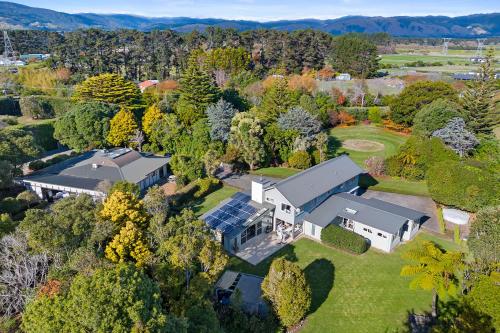an aerial view of a house with a solarium at Anam Cara Gardens luxury Villa Private bedrooms and ensuite bathrooms Sleeps 9 in Otaki