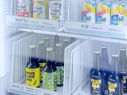 a refrigerator filled with lots of bottles of soda at LUXE TECH VILLA Ashitoku - Vacation STAY 10791v in Akaoki