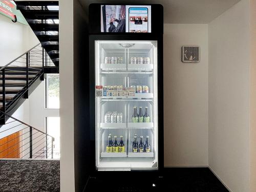 a refrigerator filled with lots of bottles of beer at LUXE TECH VILLA Ashitoku - Vacation STAY 10791v in Akaoki