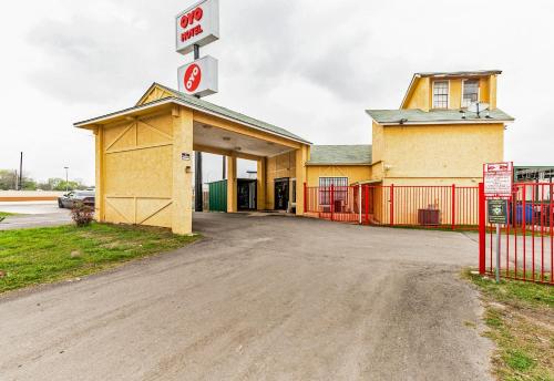 a building with a sign on top of it at OYO Hotel San Antonio Lackland near Seaworld in San Antonio