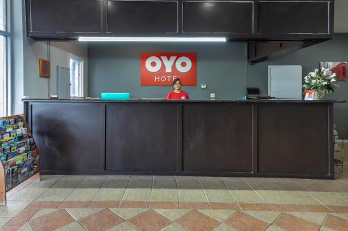 a woman standing behind a counter in an office at OYO Hotel Jennings Near Crowley, LA I-10 in Jennings