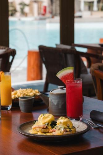 a table with a plate of food and a drink at Terra Solis Dubai in Dubai