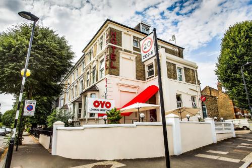 a no parking sign in front of a building at OYO London Guest House in London