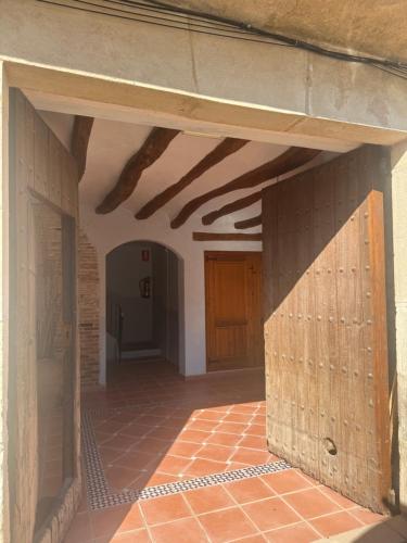 an empty hallway with wooden beams in a building at Cal Capdevila in Pira