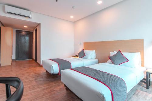 Postel nebo postele na pokoji v ubytování Super OYO Townhouse 1 Hotel Salemba