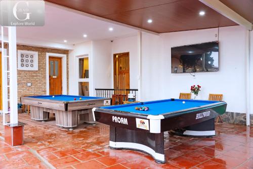 two pool tables on a tile floor in a room at Hoang Yen Villa & Coffee in Da Lat
