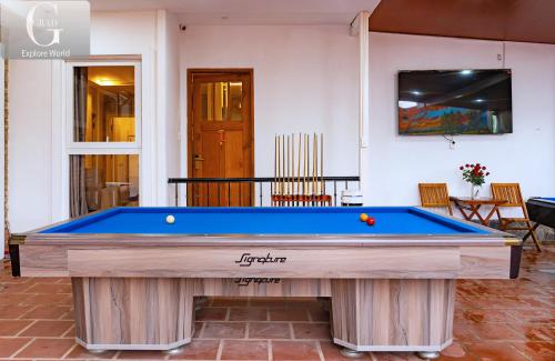 a pool table in the middle of a room at Hoang Yen Villa & Coffee in Da Lat