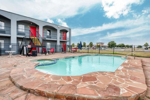 a swimming pool in front of a building at OYO Hotel San Antonio Lackland Air Force Base West in San Antonio