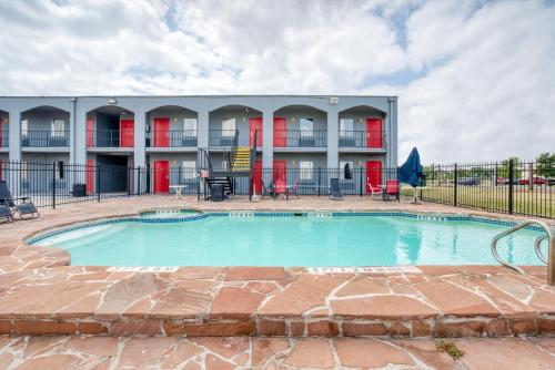 a swimming pool in front of a building at OYO Hotel San Antonio Lackland Air Force Base West in San Antonio