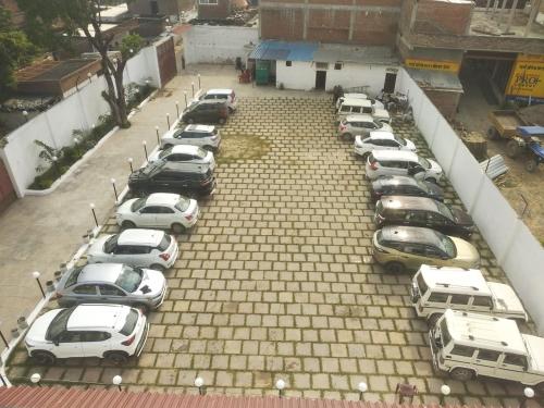 a bunch of cars parked in a parking lot at Hotel Annapurna Regency in Mirzāpur