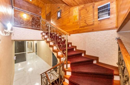a spiral staircase in a house with wooden ceilings at Viktoriya Family 2 Country complex in Kyiv