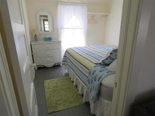 a bedroom with a bed and a dresser and a mirror at Bay Views! Wifi Bay Side Duplex In Ship Bottom in Ship Bottom