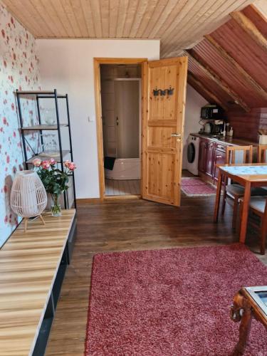 a room with a wooden door and a table at Suur-Sadama Apartment in Kuressaare