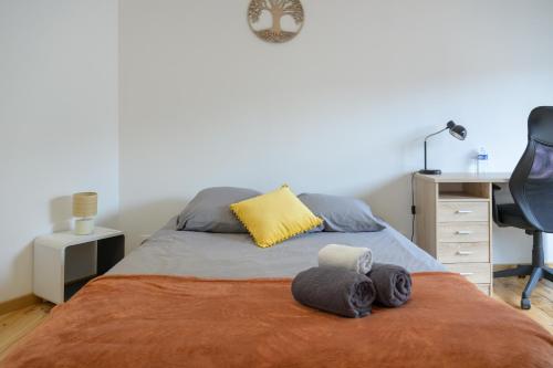 a bedroom with a bed with a desk and a chair at Grand Central Suites - 4 Chambres Premium in Pau