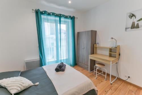 a bedroom with a bed and a desk and a window at Grand Central Suites - 4 Chambres Premium in Pau