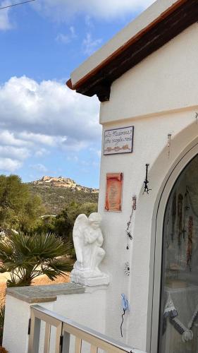 a white statue on the side of a building at Spectacular view of the Maddalena Islands in Porto Rafael