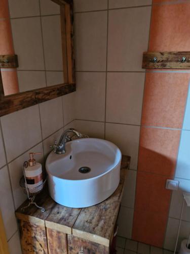 a bathroom with a white sink and a mirror at Suur-Sadama Apartment in Kuressaare