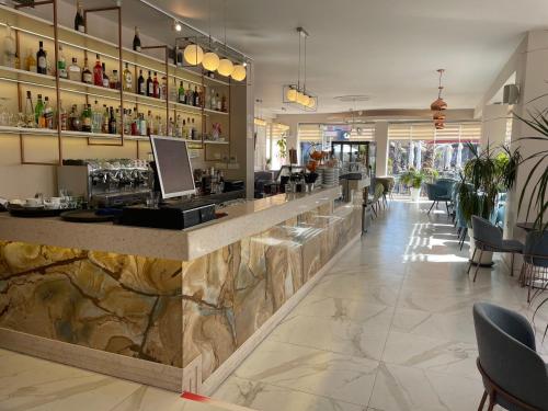 a bar in a restaurant with a marble counter at Bizant Boutique Hotel & Coffee,Bar in Durrës